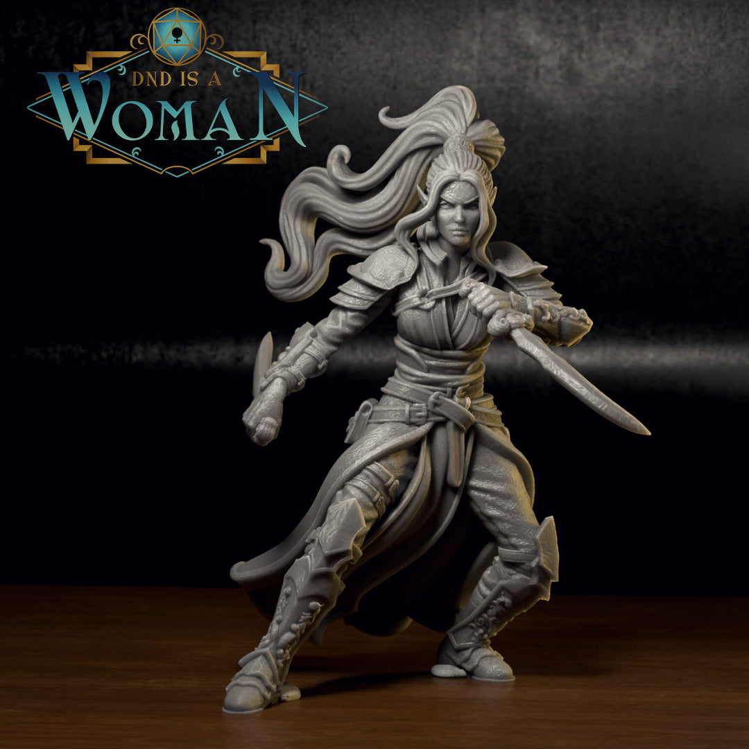 Painted grey resin miniature of a female dual-wielding rogue in a committed forward lunge, longsword levelled and short blade raised, ornate greaves and engraved bracers visible, windswept hair cresting at the crown. Sculpt by DnD Is A Woman.