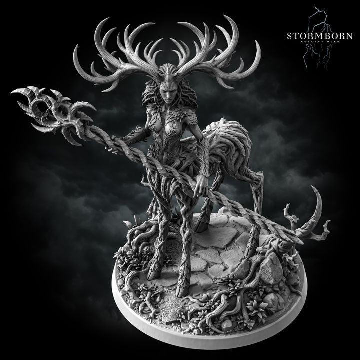 Aldara by Stormborn Collectibles — bark-and-vine humanoid figure leaning forward with thorned staff extended, antlered crown prominent, wild hair blending into organic body, scenic root-covered base.