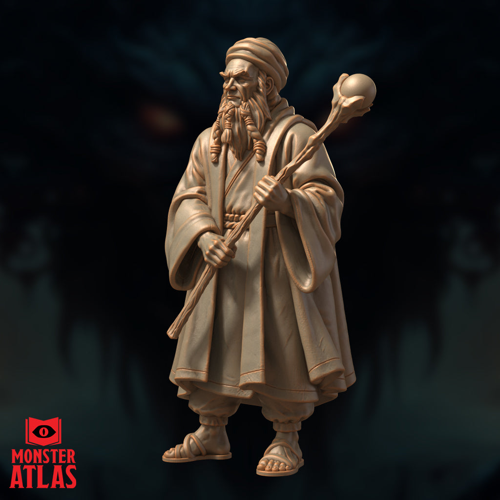 Elderly bearded male wizard in layered robes and turban, gripping a gnarled orb-topped staff in both hands, wearing sandals. Stern expression, braided beard. Sculpt by Monster Atlas.