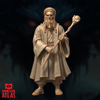 Elderly male wizard with braided beard and turban, holding a staff capped with a smooth orb, dressed in wide-sleeved robes tied with a rope sash. Grim, heavy-browed expression. Sculpt by Monster Atlas.