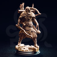 Front view of an unpainted 32mm resin miniature of Anatolius of the Far Sands — a desert ranger in layered armour and wrapped headscarf, wielding a spiked flail chain, with a bow and quiver visible over his shoulder, posed on a cracked stone base