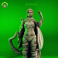 Digital render of Annah, a tiefling rogue miniature by The Toadstool Weaver. She stands in a confident pose, one hand raised at shoulder height with fingers spread, the other resting at her hip. She wears layered torso armour with a high collar, buckled bracers, belted trousers, and a flowing cape draped behind her. Her tiefling tail curls low to the ground. Long hair flows freely with a single strand curling at the crown. Expression is cool and self-assured. Grey unprimed render on a green background.
