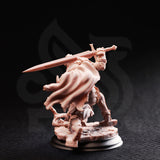 Rear view of the same unpainted resin animated armour miniature, showing the flowing cloak in full detail billowing dramatically behind the figure, with layered back-plate armour and a rubble-strewn scenic base visible — 32mm scale D&D construct miniature