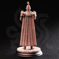 Rear view of the same unpainted resin knight miniature showing the richly detailed woven texture of the full-length cape, layered pauldrons, and plumed great helm, on a textured scenic base with a black display plinth