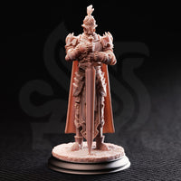 Front view of an unpainted salmon-coloured resin miniature of a heavily armoured knight in full plate, holding a large two-handed sword point-down before them, wearing a plumed great helm and a sweeping cape, mounted on a textured scenic base with a black display plinth