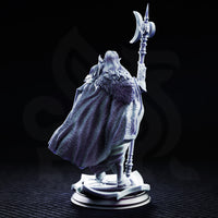 Drow male paladin gripping a crescent-tipped ceremonial polearm, armoured in chest plate with scale skirts and a detailed belt, long hair framing a composed expression, displayed on a decorative sculpted base. Sculpt by DM Stash.