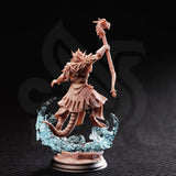 Rear three-quarter view of Artizak Stormscale unpainted resin miniature — showing the detailed back of the scale-textured coat, spiked crest, dragonhead staff raised aloft, and the dragonborn's tail sweeping through the chaos-wave base