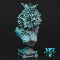 Digital render of the Avatar of Spring bust by Witchsong Miniatures — a horned female nature spirit with a dense crown of sculpted flowers and foliage, narrowed eyes, bark-textured torso, and an integrated stone plinth base, shown in teal-tinted grey against a dark background