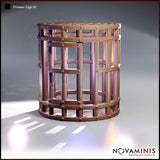 Digital render of a cylindrical iron prisoner cage miniature terrain piece by Novaminis, showing thick vertical bars, rivet-studded banding, and a solid flat top, viewed from a front three-quarter angle against a grey background