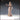 Digital render of Novaminis Noble 02 — a composed noblewoman in an embossed floor-length gown with a decorative chain belt, braided beaded hair, and wide cuffs, one hand raised in a gesture of address, 32mm scale resin miniature, unpainted