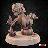 Baby Fruit Drake by Mia Kay M3DM — a plump, round-bellied draconic creature with a succulent-leaf mane and small leafy winglets, perched on a pumpkin surrounded by tiny flowers and a butterfly on a stem.