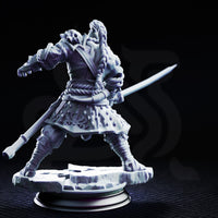 Orc warrior in rope-bound samurai-style armour gripping a curved sword at waist height, knees bent and weight low as if reading an opponent's movement. Skull mounted on pauldron, hexagonal-patterned fabric skirt. Sculpt by DM Stash.