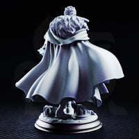 Male sorcerer in a long belted coat, holding a fractured arcane focus staff low at his side, curly hair, determined expression, on a round scenic base with broken stonework. Sculpt by DM Stash.