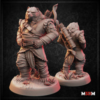 Two unpainted grey resin Bearfolk Ranger miniatures shown front and back — a large bear-folk figure in layered leather armour with buckled chest strapping, carrying a bow and arrow quiver, standing on a detailed naturalistic base with small plants and crystals
