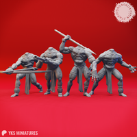 Four unpainted grey resin Blemmye miniatures in a group render against a red background — left to right: a spear-sweeping warrior, a crouching blowgun shooter, an overhead spear striker with mouth open in a roar, and a claw-lunging figure with arms spread wide; all feature the classic headless chest-face design with bound ankle wraps and loincloth skirts