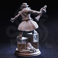 Photograph of the unpainted grey resin Brains goblin gangster miniature from the rear — showing the long flowing coat with visible wear lines, wild hair beneath the top hat, the blunderbuss raised in the right hand, and the reverse of the TNT crate base including a sack on the ground and additional crate detail