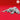 Unpainted grey resin Bulette miniature in a low, crouching pose — armoured plates across the back, splayed claws, and dorsal fins visible — photographed against a red background