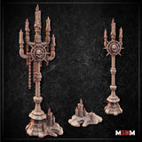 Unpainted resin renders of the Gothic Candelabra Set by Mia Kay M3DM — showing three terrain pieces: a tall skull-medallion candelabra with hanging chains, a slender variant candelabra, and a small melted-candle cluster base, all in warm beige resin against a dark stone background