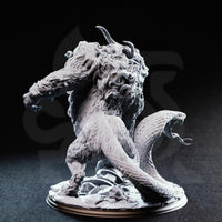 Capricalion Chimera resin miniature — rear three-quarter view showing serpent tail rearing with open fanged mouth, clawed forelimb raised, and heavily textured fur and scale detail across the body, unpainted grey resin