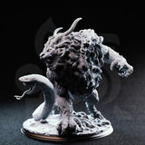 Capricalion Chimera resin miniature — front three-quarter view showing roaring lion head, secondary goat head with curved horns, raised serpent tail, and detailed flowing mane, unpainted grey resin on rocky base