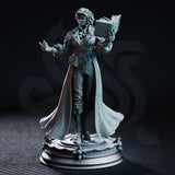 Carina Braithwaite sorceress miniature by DM Stash — one hand raised mid-cast, other hand holding an open tome, wearing a belted greatcoat and sweeping embossed cloak, on a detailed arcane base.