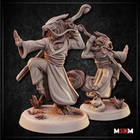 Two unpainted grey resin dragonborn monk miniatures shown side by side — the larger foreground figure strikes a raised-knee martial arts stance with staff swung overhead and one hand extended in a warding gesture, wearing layered flowing robes with a rope belt; the smaller background figure mirrors a similar pose from a different angle, both on detailed round bases with desert plants and broken stone
