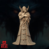 Illiquid Clairvoyant Chishinix by Monster Atlas — robed illithid figure standing upright, arms crossed, cradling a tentacled skull against the chest, tentacles curling from the cephalopod face, swept-back horns framing the head, layered geometric robes with a skull motif on the front panel.