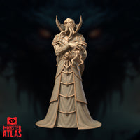 Illiquid Clairvoyant Chishinix by Monster Atlas — robed illithid figure standing upright, arms crossed, cradling a tentacled skull against the chest, tentacles curling from the cephalopod face, swept-back horns framing the head, layered geometric robes with a skull motif on the front panel.
