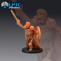 Skeletal commander mini by Epic Miniatures, sword raised overhead in a war cry, holding a broad shield, wearing ornate tribal-carved breastplate, greaves, and a flowing cloak, bare bone limbs visible between armour panels.