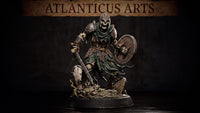 Armoured skeleton warrior striding forward over a base of skulls and cracked tombstones, clutching a lowered longsword and raising a battered round shield, wearing plate armour and a visored helmet with a tattered cloak. Sculpt by Atlanticus Arts.