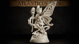 Winged pixie miniature gripping a gnarled root staff topped with a hollow mask, one hand raised, wearing leaf-and-feather armour, standing on a mushroom-scattered base. Sculpt by Atlanticus Arts.