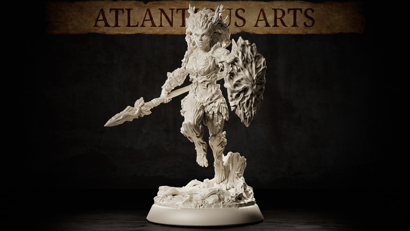 Dryad Warrior by Atlanticus Arts: bark-armoured female figure mid-stride, thorn-tipped spear extended forward, large gnarled wood shield on her left arm, wild branching hair, standing on a sculpted tree-stump root base.