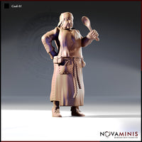 Front-facing digital render of Cook 01 by Novaminis — a stocky human male miniature in a long apron, one hand on hip, the other raised holding a wooden ladle, with a rope belt, utility pouch, and cloth head wrap. Unpainted resin, 32mm scale.