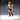 32mm unpainted resin miniature of a bare-chested male tavern patron holding a large tankard, wearing lace-up leather trousers and boots, with a confident smirk — Drunk Patron 01 by Novaminis