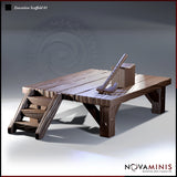 Raised wooden execution platform with plank-top deck, cross-braced legs, and a side staircase. A chopping block and hand axe sit on the platform surface. Sculpt by Novaminis.