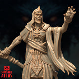 Close-up render of the Deathlock Mastermind miniature showing its skeletal face with horned crown, raised clawed hand, beaded amulet, and arcane-engraved tabard — unpainted gold-toned render by Monster Atlas