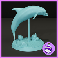 A dolphin leaping mid-arc, mounted on a slim support rod above a round scenic base textured with rippled water, two rocks, and a cluster of aquatic plants. Sculpt by Ella's Arcanum Minis.