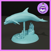 Dolphin miniature leaping above a scenic oval seabed base with kelp clusters, sea anemones, and rounded boulders. Smooth arched body mounted on a slender support column. Sculpt by Ella's Arcanum Minis.