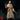 Robed male spellcaster standing upright, right hand raised palm-out at chest height, left hand holding a slender wand. Wide embossed runic cape over long flowing robes with belted pouch. Sculpt by Monster Atlas.