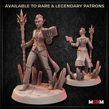 Digital render showing front and back views of an unpainted drow sorceress miniature — she holds a spiked staff in one hand and an open dragon-scale spellbook in the other, wearing a tailored coat with scaled hem details, standing on a crystal scatter base