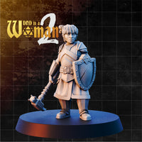 Stocky female dwarf cleric holding a riveted kite shield on her left arm and a mace lowered in her right hand, wearing layered plate and padded armour with a studded belt, hair pinned up in a loose knot, calm determined expression. Sculpt by DnD Is A Woman.