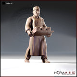 Front-facing digital render of Baker 01 miniature by Novaminis — a male human baker in cap, apron and sturdy shoes, holding a wooden tray loaded with bread loaves at waist height. Unpainted clay-coloured resin render at 32mm scale.