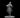 Unpainted grey resin digital render of a female elf bard miniature at 32mm scale, shown playing a violin with bow in hand, wearing a travelling cloak and belted tunic, with a braided hairstyle and a subtle smile, mounted on a round flat base