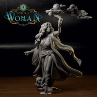 Grey resin print of elf druid Cilarien raising sculpted storm clouds overhead, flowing robes, extended free hand, and detailed sandalled feet on a small sculpted base. Sculpt by DnD Is A Woman.