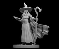 Elven female wizard standing upright, holding an open spellbook in one hand and a tall curved staff in the other, wearing a wide-brimmed pointed hat, flowing robes, and a billowing cloak. Sculpt by MZ4250.