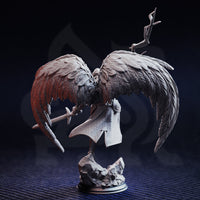 Rear view of the Erdrydion angel warrior miniature — showing intricate feather detail across both large wings, woven cloak texture, longsword held behind, and twisted sceptre raised aloft, mounted on a rocky scenic base.