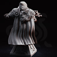 Hooded crossbow knight bust, raised crossbow aimed forward, chainmail coif and armoured helm, fur-trimmed cloak, ornate plinth base with cross motif. Sculpt by DM Stash.