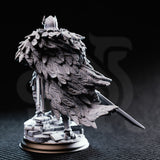 Photograph of unpainted grey resin Eulysses the Eversighted miniature — rear view showcasing the sweeping owl-feather cloak with individually sculpted feather barbs and quills, and the owl-crested helmet silhouette