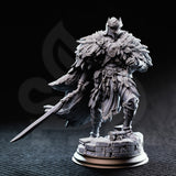 Photograph of unpainted grey resin Eulysses the Eversighted miniature — front-facing view showing layered feather pauldrons, sun-disc chest medallions, feather tassels at the waist, and articulated leg armour on a cobblestone base