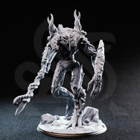 Front view photograph of the unpainted grey resin Evarak Treant of Duskweave miniature, showing the hollow mask-like face, mushroom growths on the torso, deeply textured bark surface detail, and barbed branch-flail weapon. Mini is posed dynamically with one leg raised.